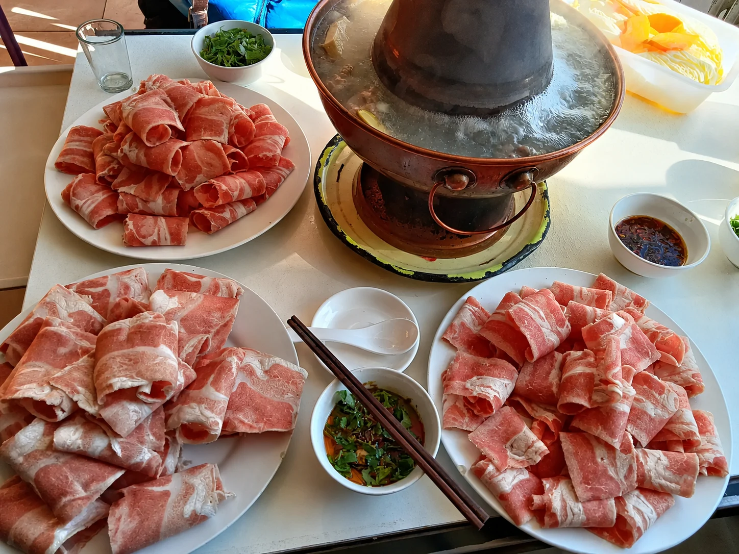 A Beijing copper hotpot with thin lamb slices and sesame sauce