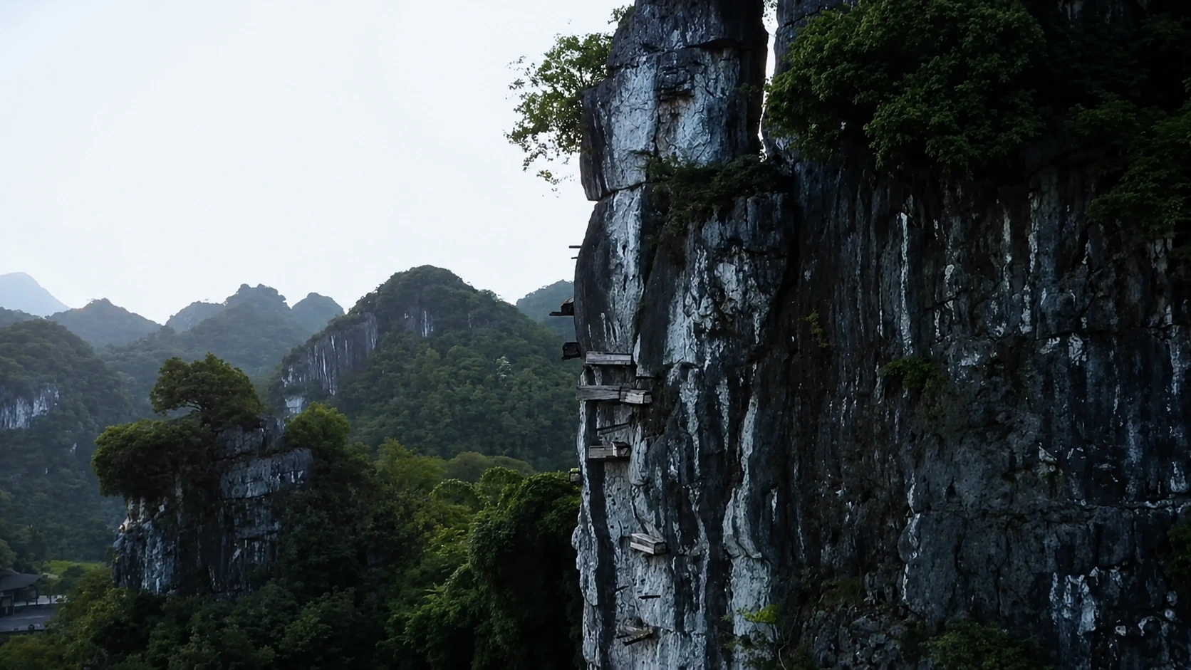 Wooden coffins wedged into a sheer cliff face
