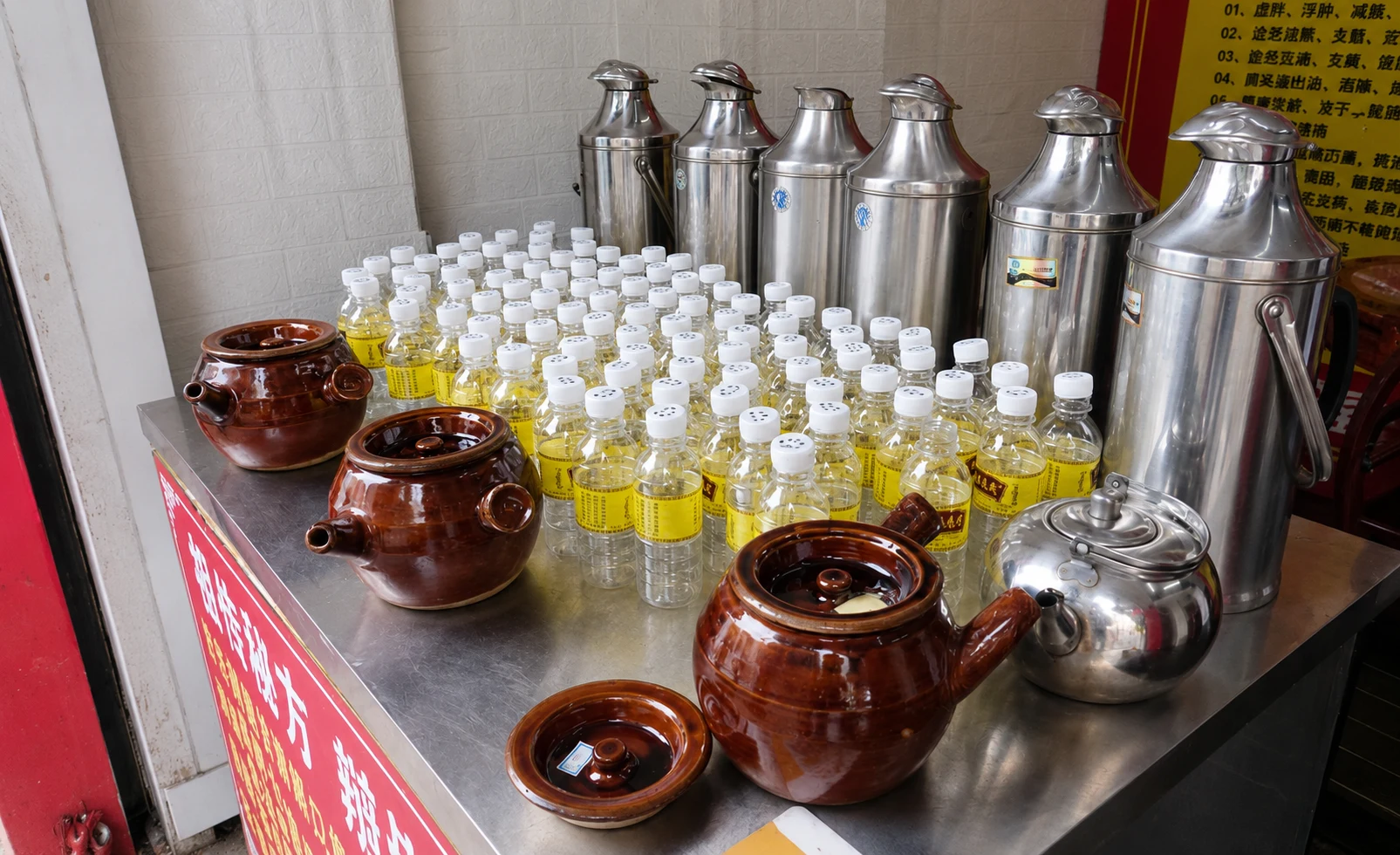 Plastic bottles filled with dark herbal tea for takeaway