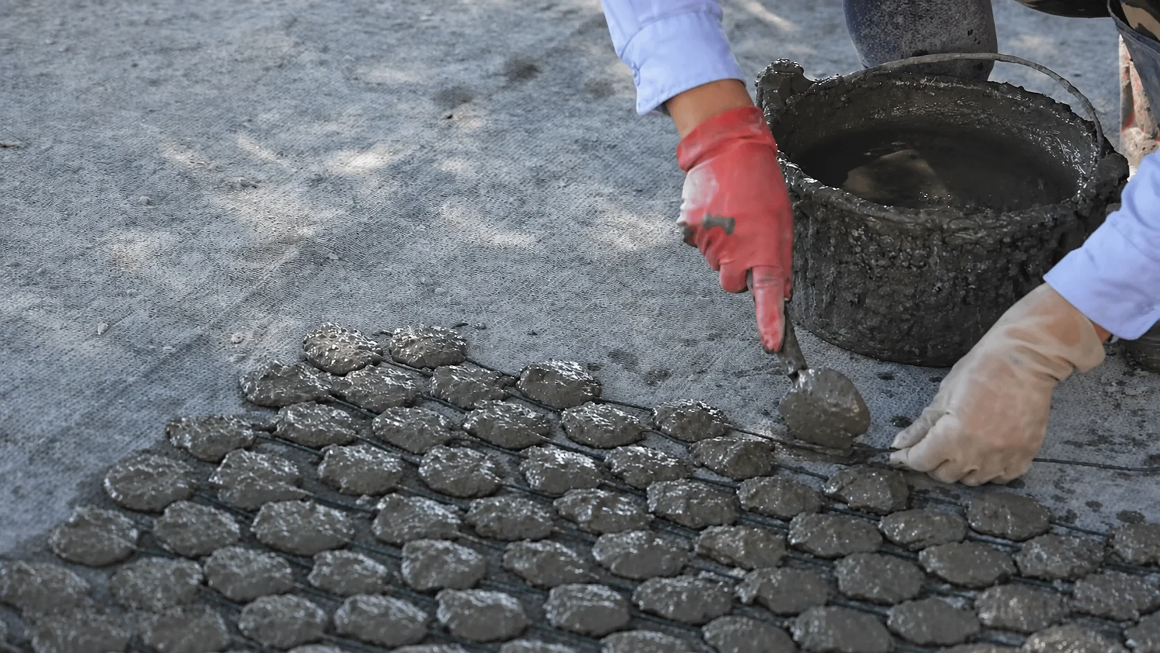 A farmer preparing cement blocks for oyster spat