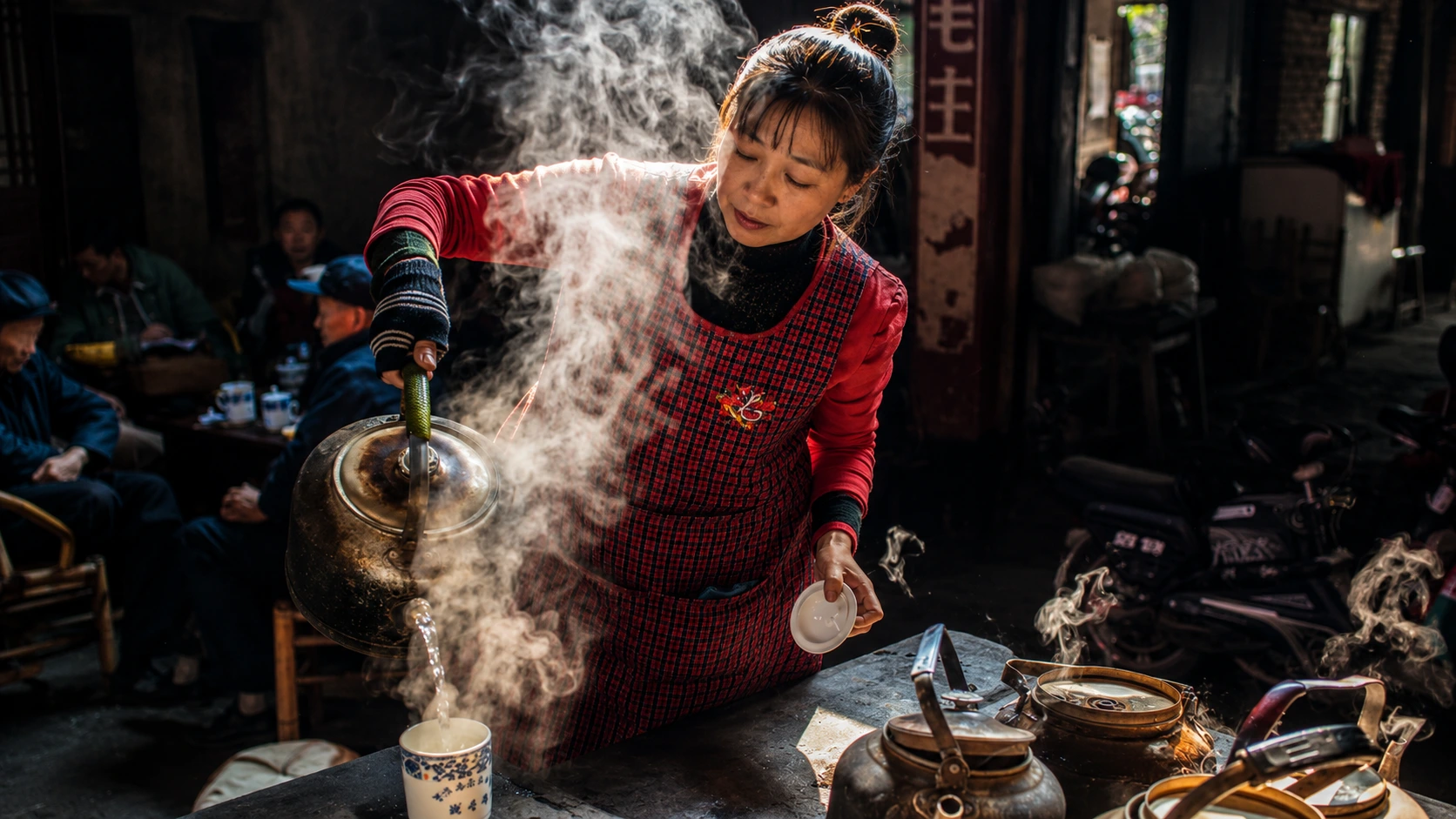 An old customer sitting on a bamboo chair with gaiwan tea in Chengdu