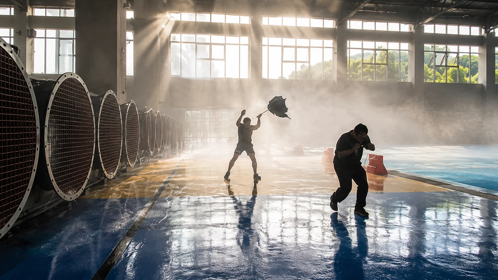 A participant braces against powerful wind and rain inside a typhoon simulator in Hangzhou