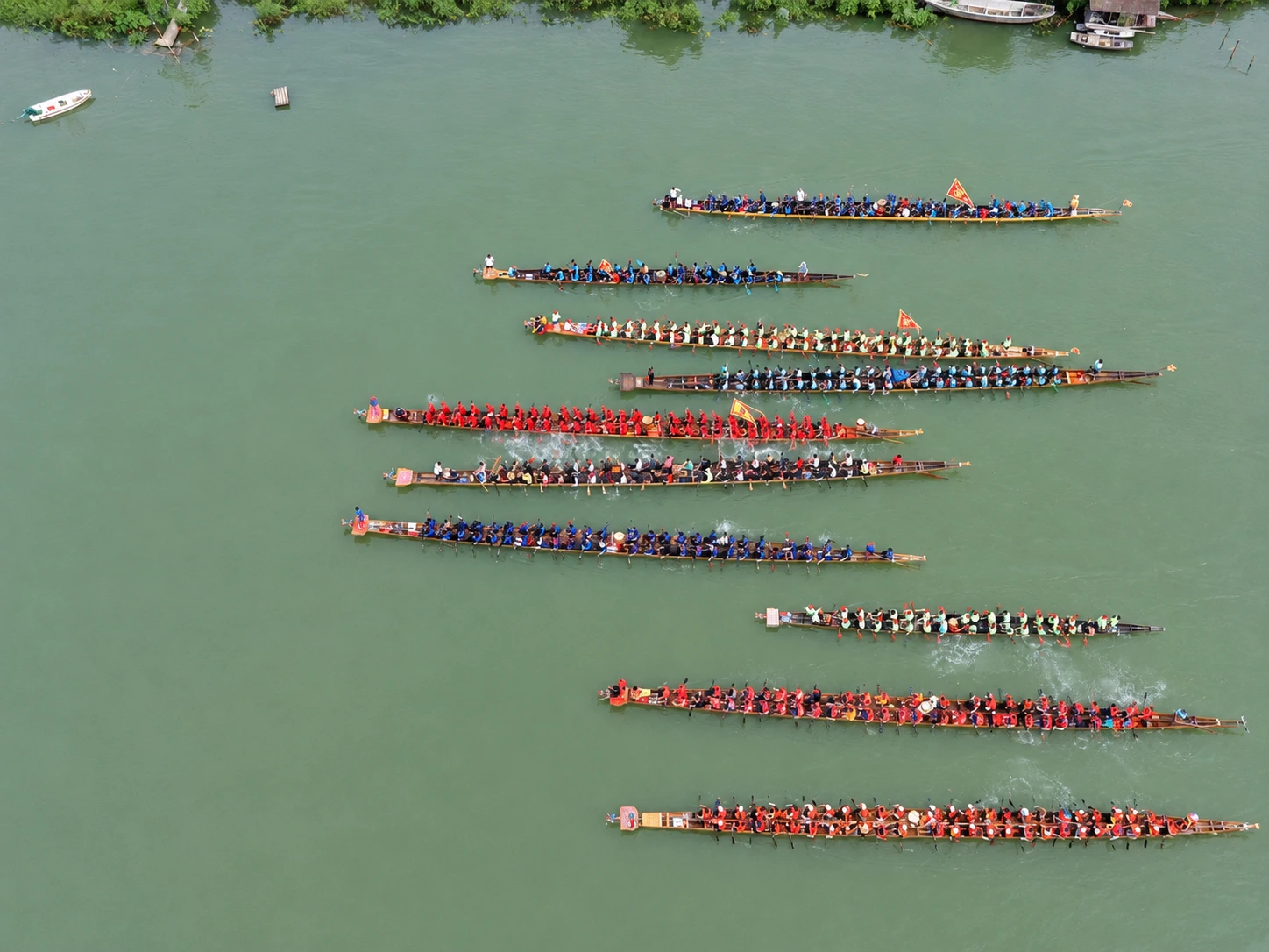 Dragon boat teams line up at the starting line