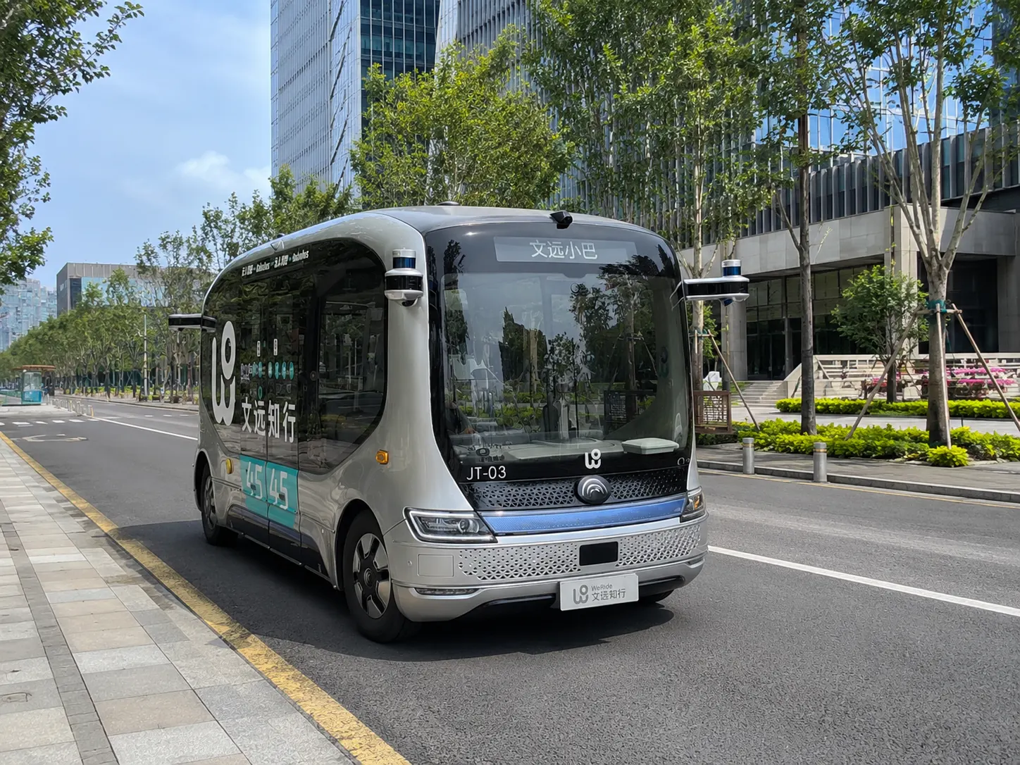 A self-driving bus navigating a Guangzhou city street