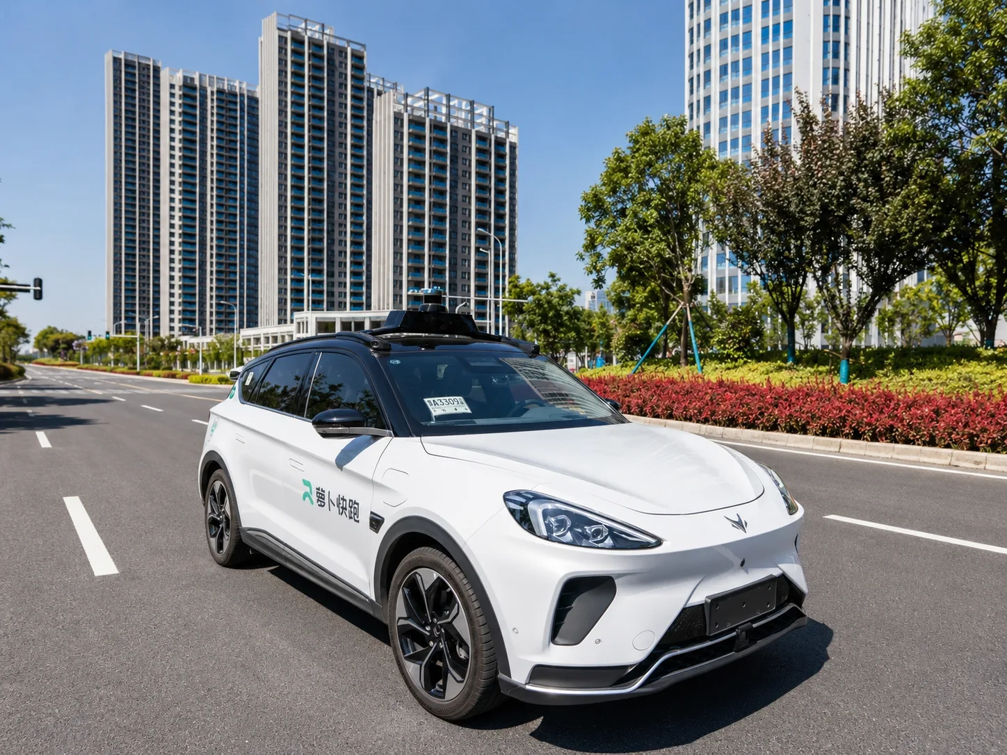 A driverless taxi waiting on a Guangzhou street with no one in the driver's seat