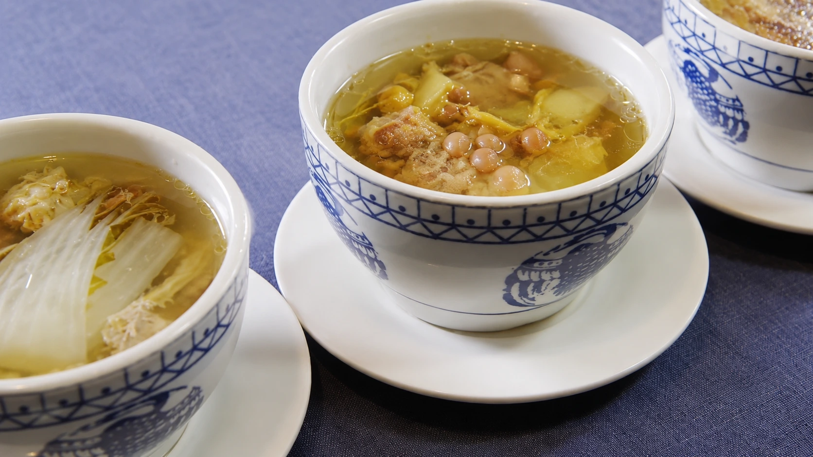 A clay pot of Cantonese slow-cooked old fire soup, steam rising gently from the dark herbal broth