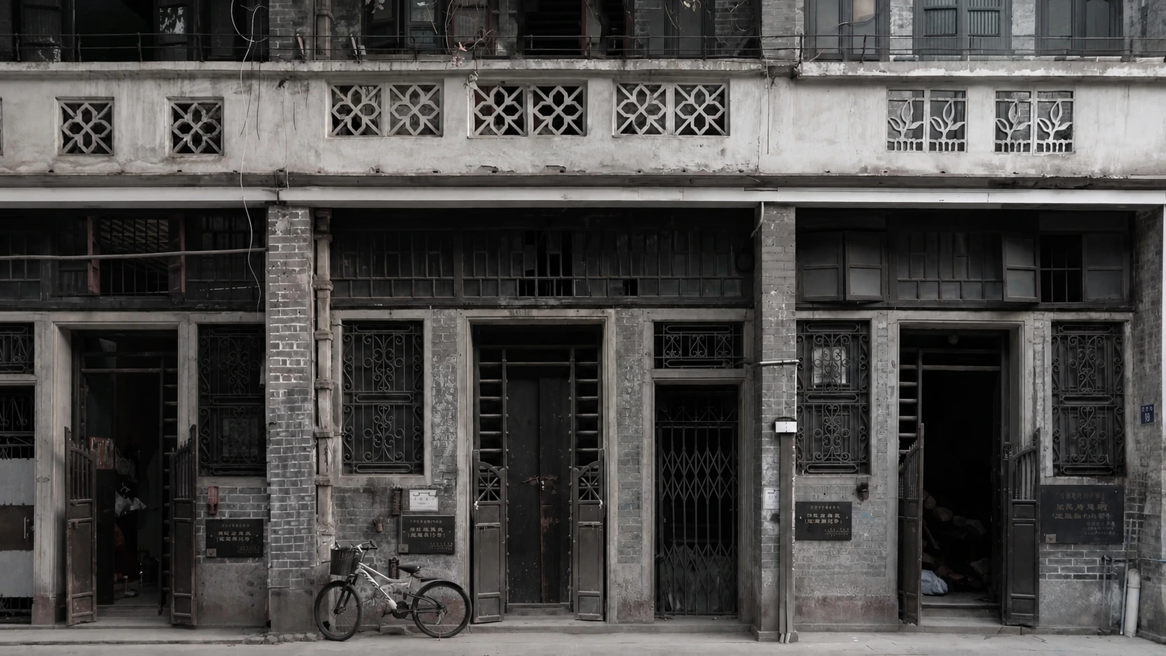 A traditional Sai Kwan mansion in Guangzhou, with blue-gray bricks, carved wooden doors, and a distinctive sliding gate