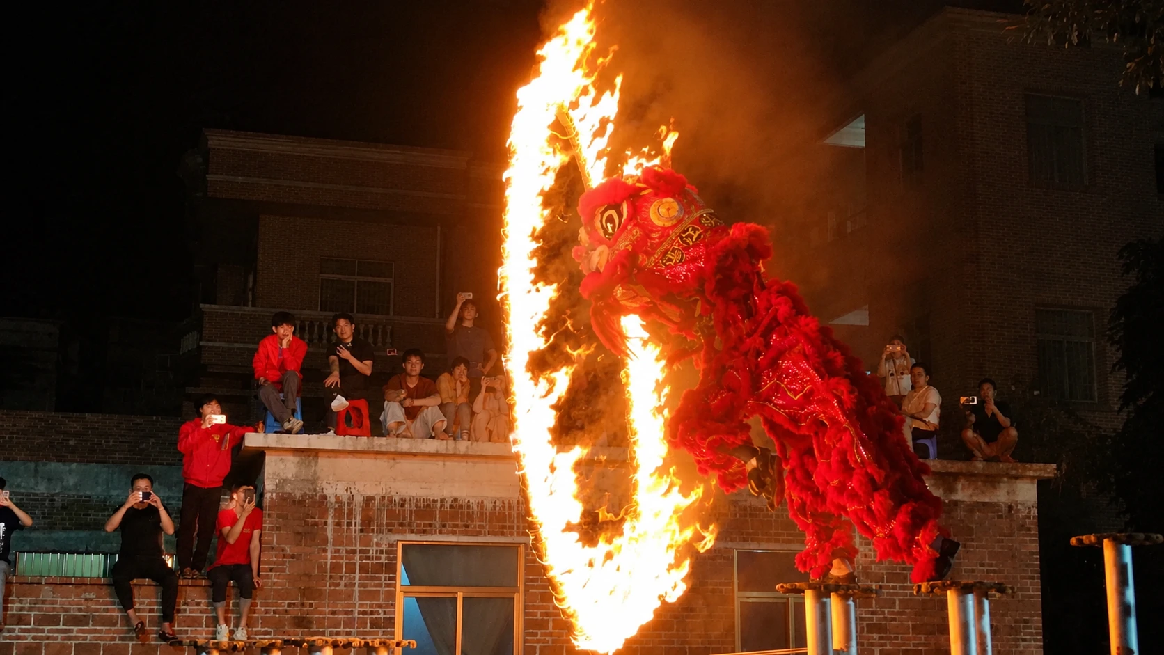Lion dance troupe performing with drummers