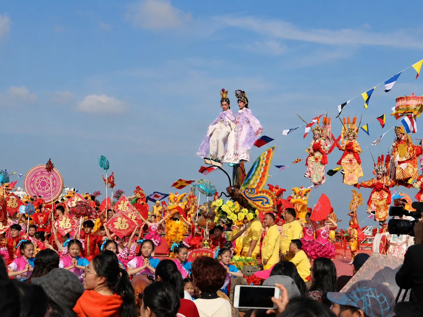 Young performer balanced on ornate butterfly antenna
