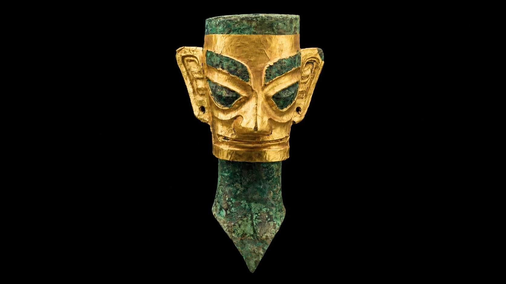 The famous golden mask of Sanxingdui displayed in a museum case under dramatic lighting