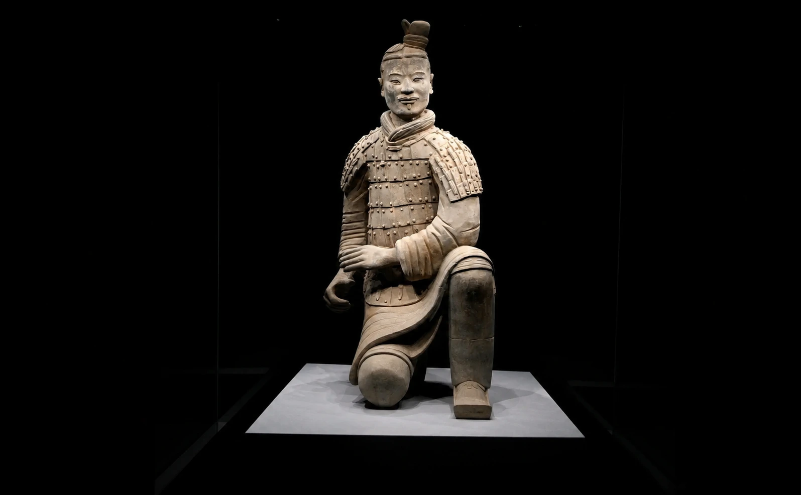 Rows of standing terracotta warriors in formation inside the underground pit