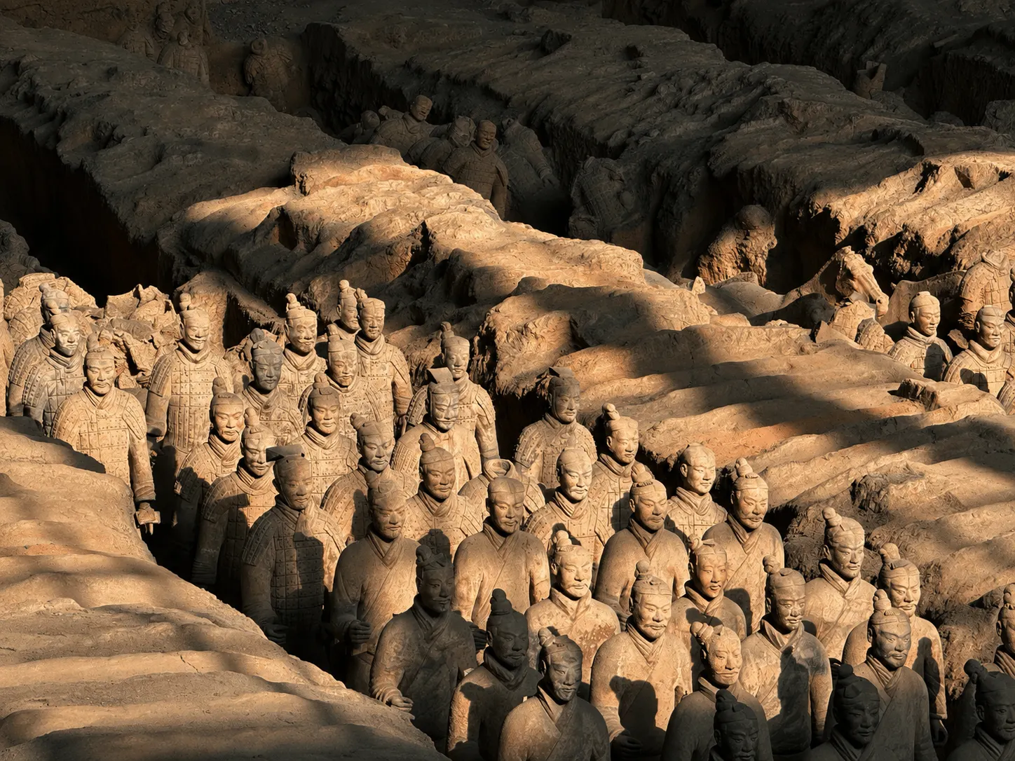 Rows of Terracotta Warriors standing in an excavation pit near Xi'an