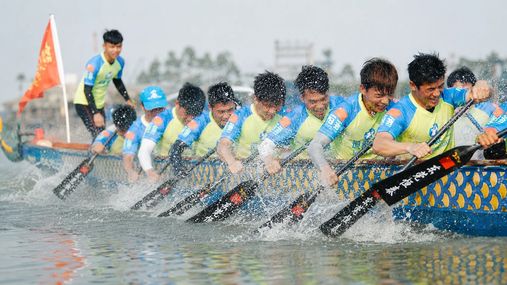 A dragon boat with a carved dragon head gliding across the Miluo River near Yichang during the Dragon Boat Festival